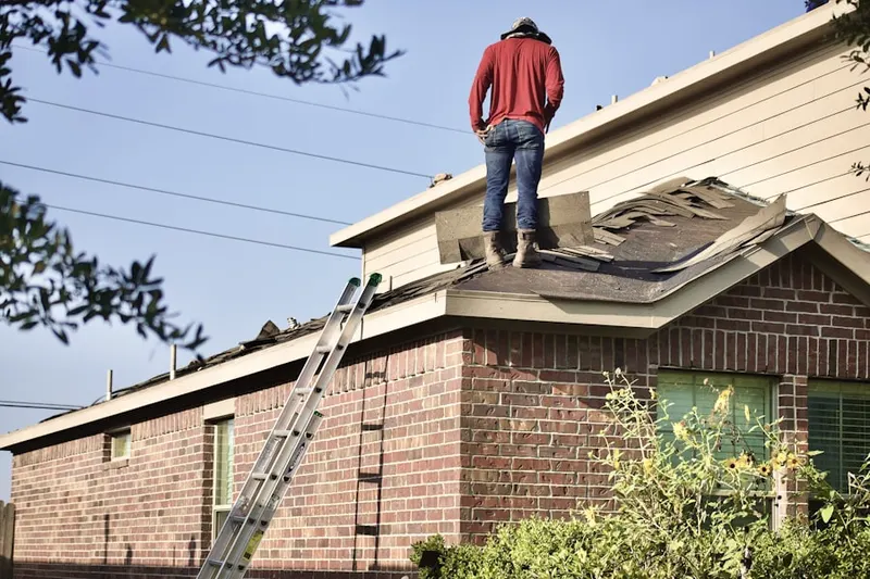 Professional roofer working on a residential roof in Meade Heights